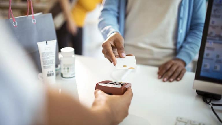 woman paying with credit card at pharmacy tKE.width .jpg