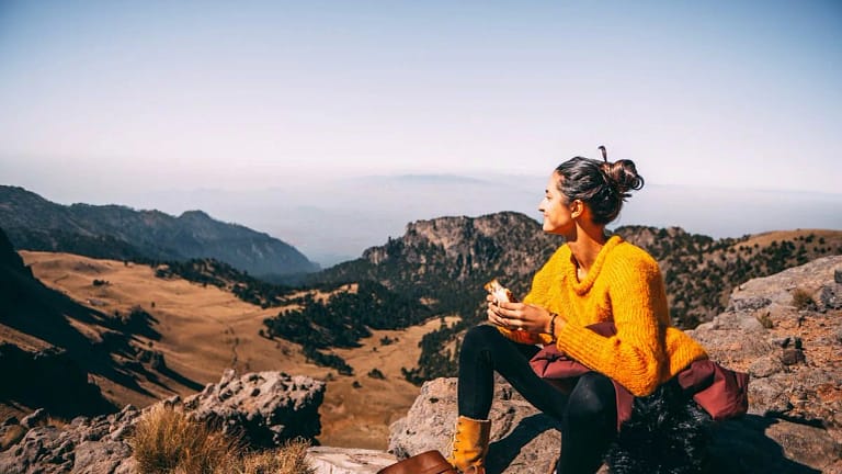 woman resting on hillside hike clGvh.width .jpg