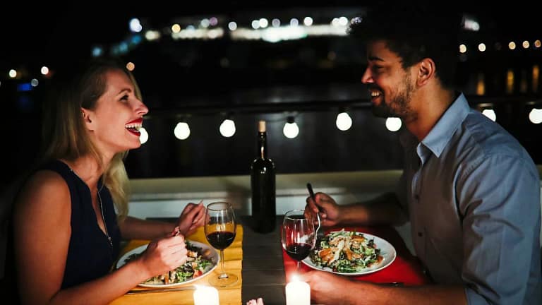 young man and woman sitting at table eating d.width xnzmD.jpg