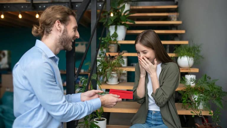 Man hands young girl a gift in an envelope zh.width .jpg