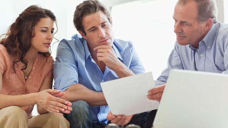 Mature man going over paperwork with young co.width iTNbwX.jpg