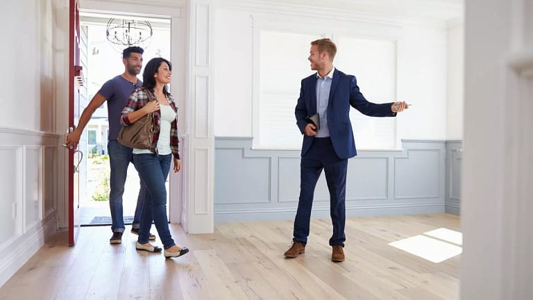couple viewing house with realtor.width .jpg