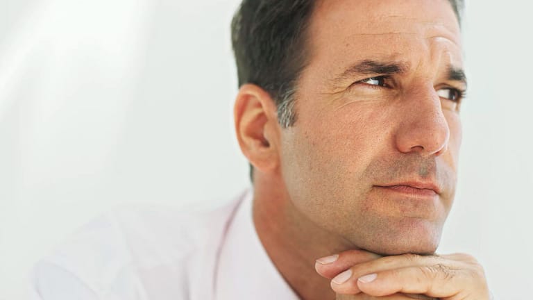 getty images mature man thinking with chin resting on hands planning retirement.jpeg