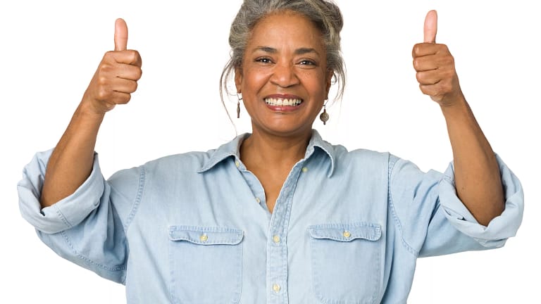 getty thumbs up yes on track early retirement millionaire happy.jpg