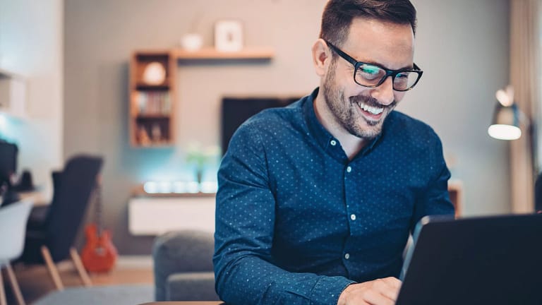 man s smiling laptop gettyimages .jpg