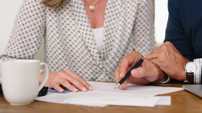 man and woman torsos signing document.jpg