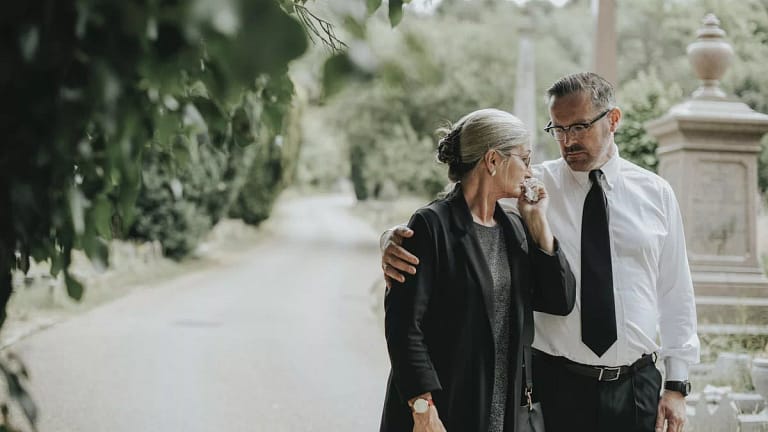 man comforting woman at funeral.width .jpg