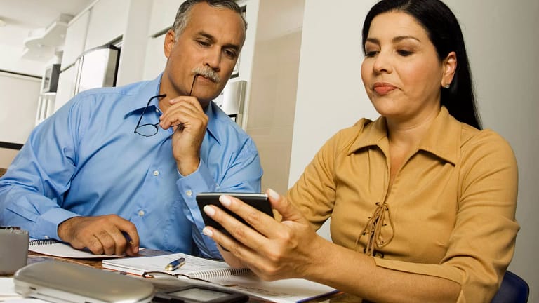 middle aged couple with calculator.jpg