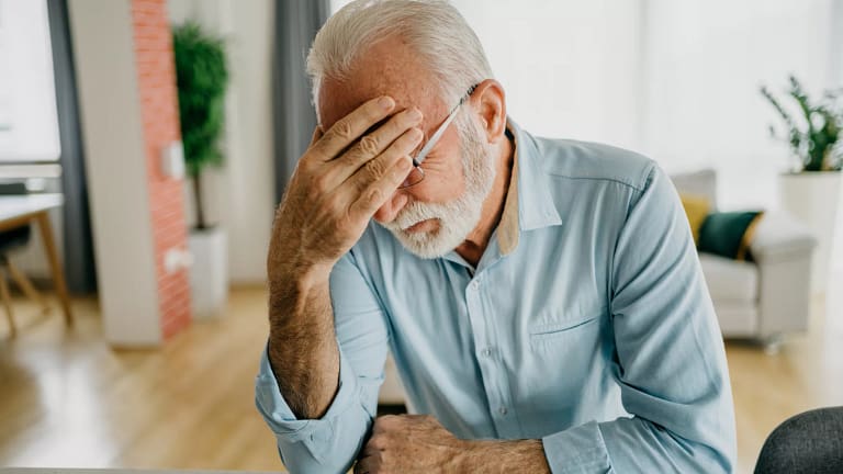 older man holding his head gettyimages .jpg