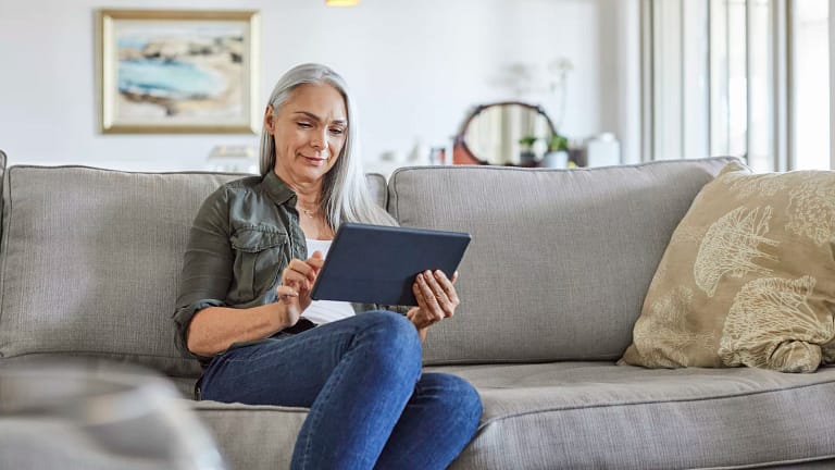 older woman couch tablet gettyimages .jpg