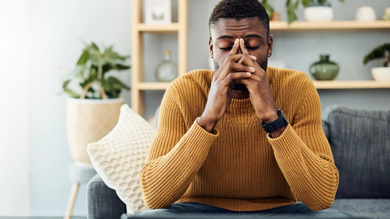 person sitting on a couch feeling worried.jpg