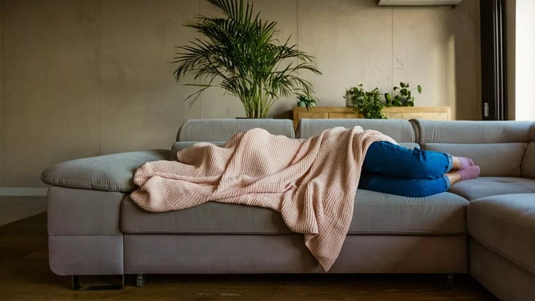 sick person on couch under blanket vzOhDg.width .jpg