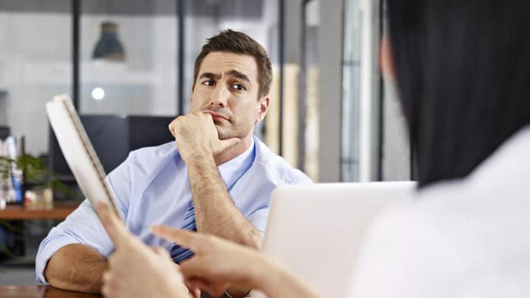 skeptical interviewer looking at interviewee .width AiEaj.jpg