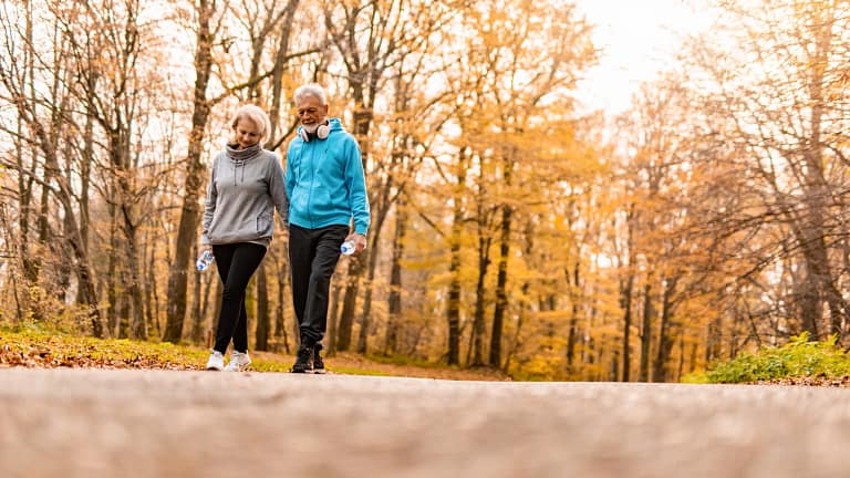 two older people walking in a park.jpg