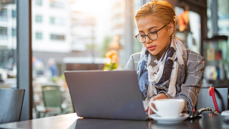 woman s laptop serious at coffee bar gettyimages .jpg