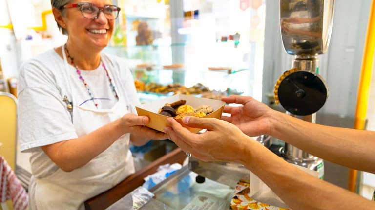 Mature woman selling a box of baked goods jJi.width .jpg
