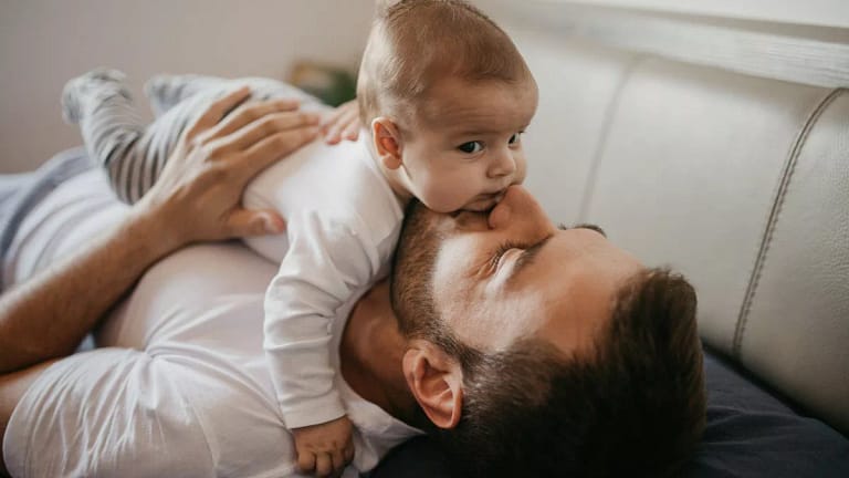 parent and baby on couch UhhpZIa.width .jpg
