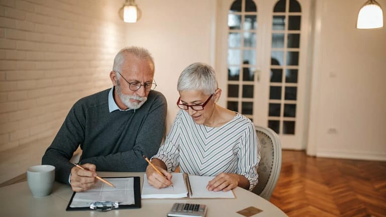 elderly couple with notebook and calculator c.width .jpg