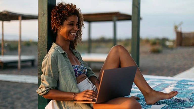 person at beach with laptop ZozlRL.width .jpg