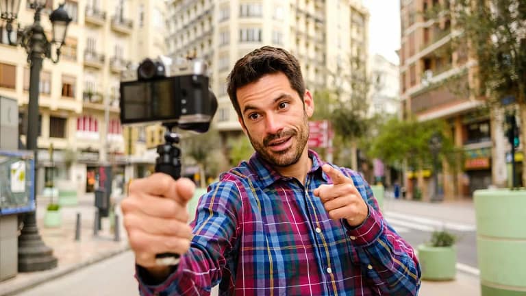 Person outdoors recording a video of himself .width .jpg