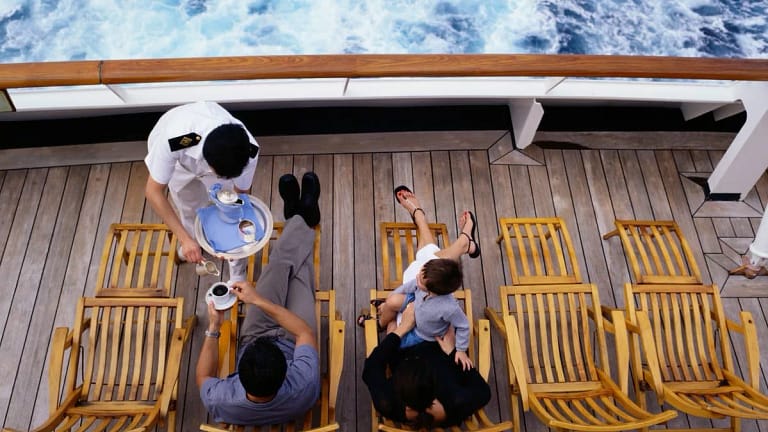 Server bringing family drinks as they lounge .width .jpg