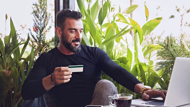 man in cafe with credit card and laptop.width .jpg