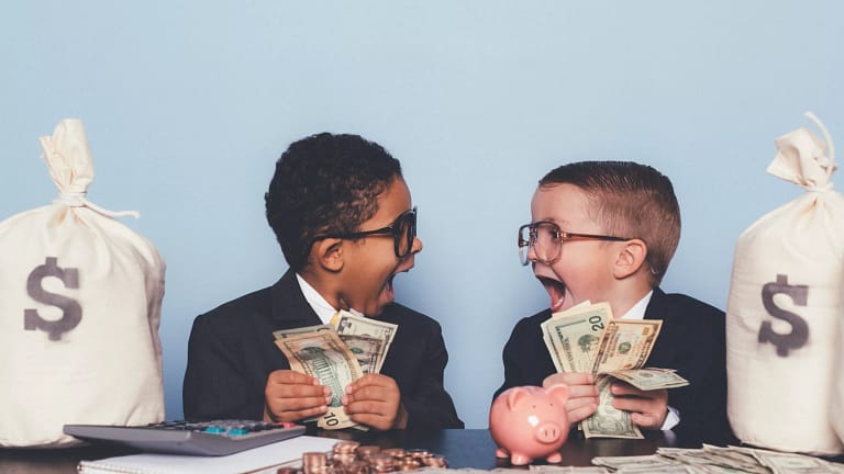 getty children kids amazed money getting rich get rich dollars.jpg