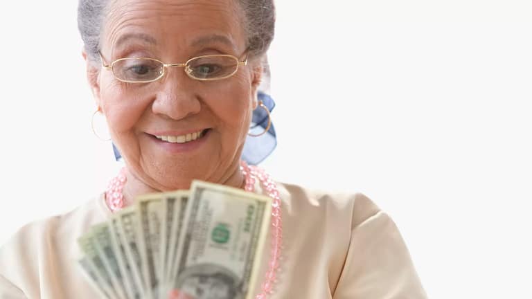 getty happy person with fanned out cash money.jpg