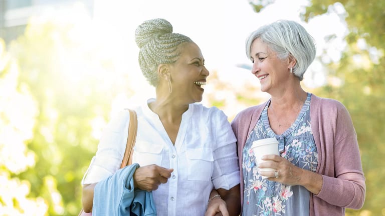 two older people walking outside smiling.jpg