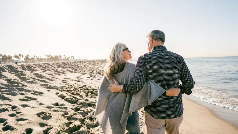 two people walking on the beach hugging.jpg