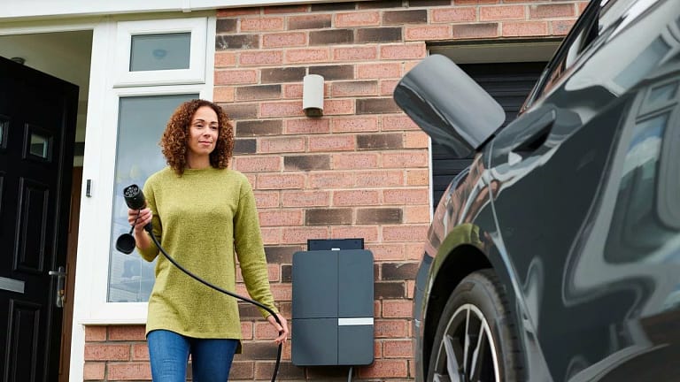 Car owner charging her EV or hybrid vehicle. .width .jpg