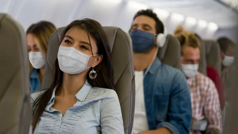 Masked passengers on a plane GaAbt.width .jpg