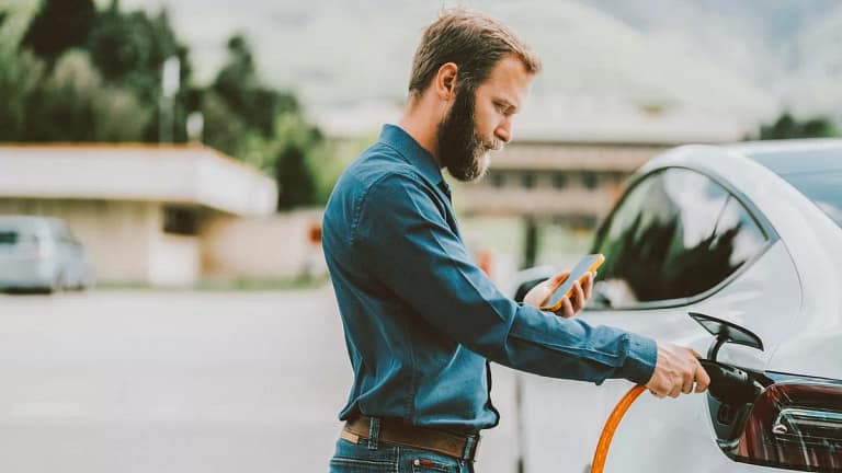Person connecting their EV to power source wh.width .jpg