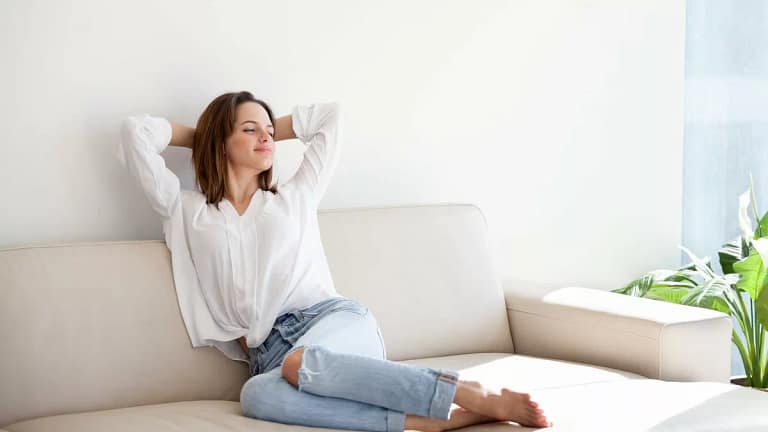 Relaxed woman on couch LrtAVD.width .jpg