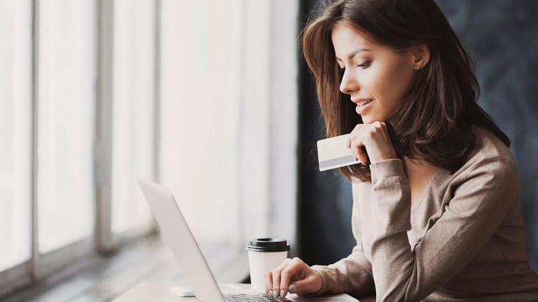 Woman on laptop with credit card BLbaw.width .jpg