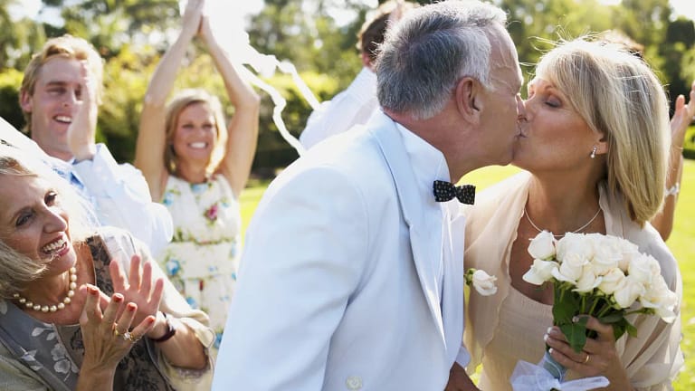 mature couple getting married kiss with bouquet x cbe.jpg