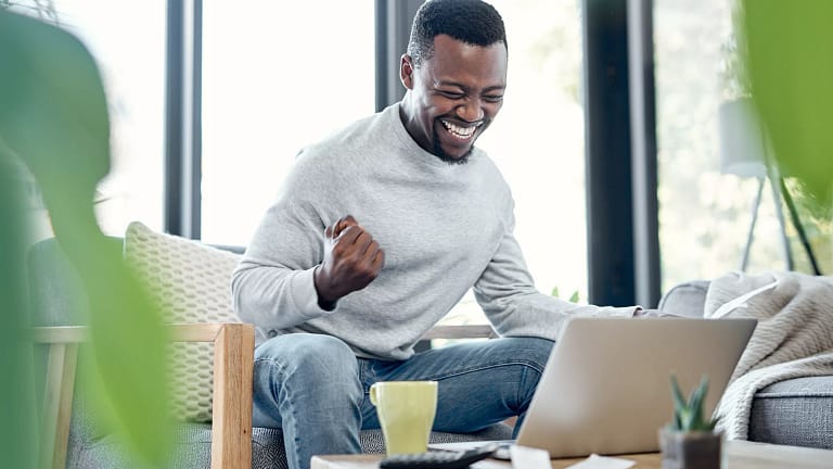 person celebrating success on laptop.jpg