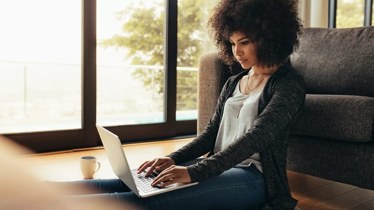 person sitting on floor using laptop.jpg