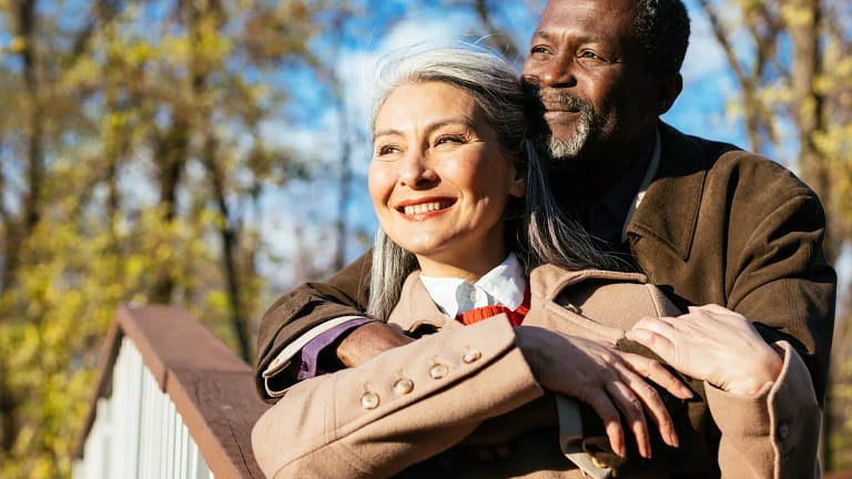 retired interracial couple hugging in love x aae.jpg