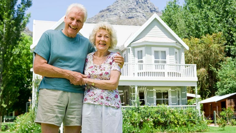 senior couple outside of larger home gettyimages .jpg