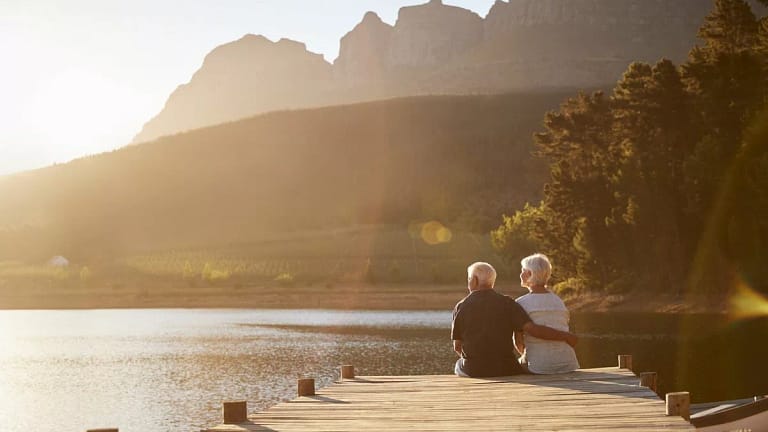 senior man and woman sitting at the end of a .width eBYYor.jpg