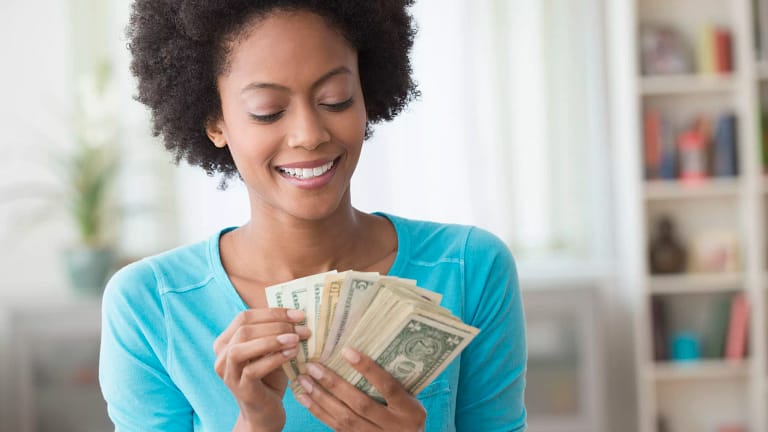 smiling person counting money.jpg