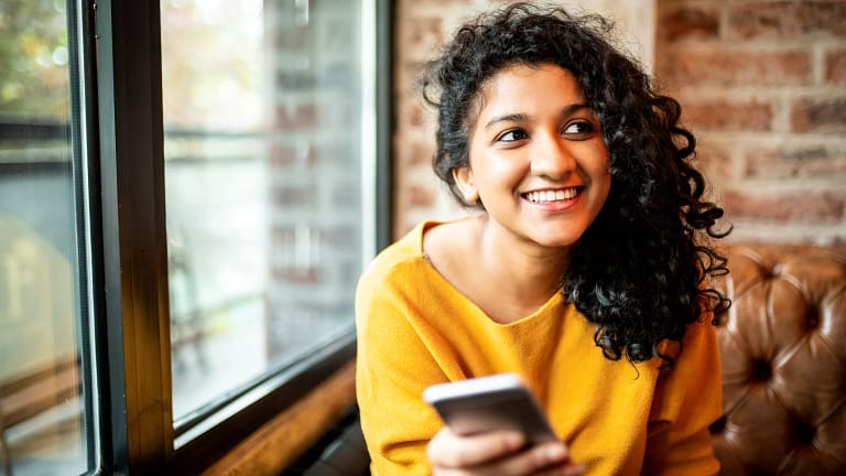 smiling person with phone.jpg