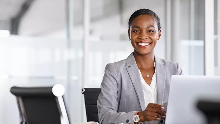 woman s smiling desk gettyimages .jpg