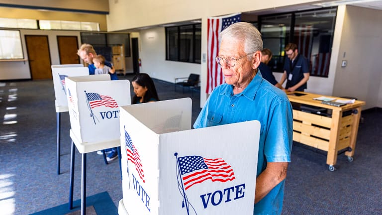 election day person voting in booth.jpg