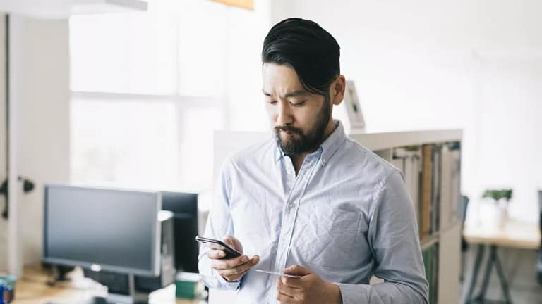 man holding phone and credit card.width .jpg