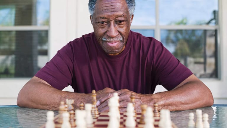 older man playing chess strategy moves winning.jpg