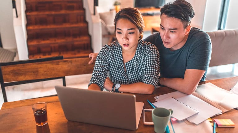 serious couple looking at laptop and discussing finances.jpg