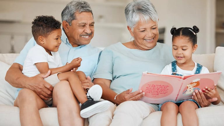 smiling couple reading books to children.jpg