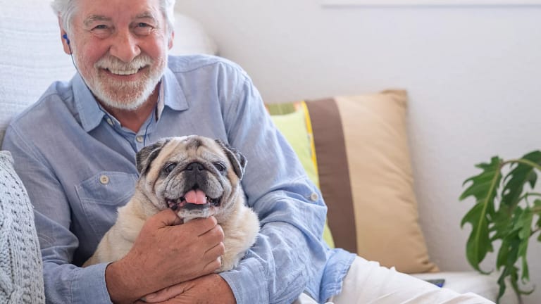 smiling person holding dog gettyimages .jpg